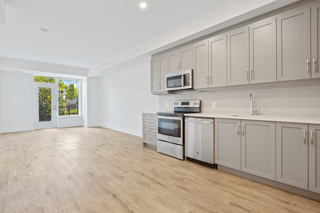 white-wooden-kitchen-cabinet-near-white-wall-1bqaggpwi7e